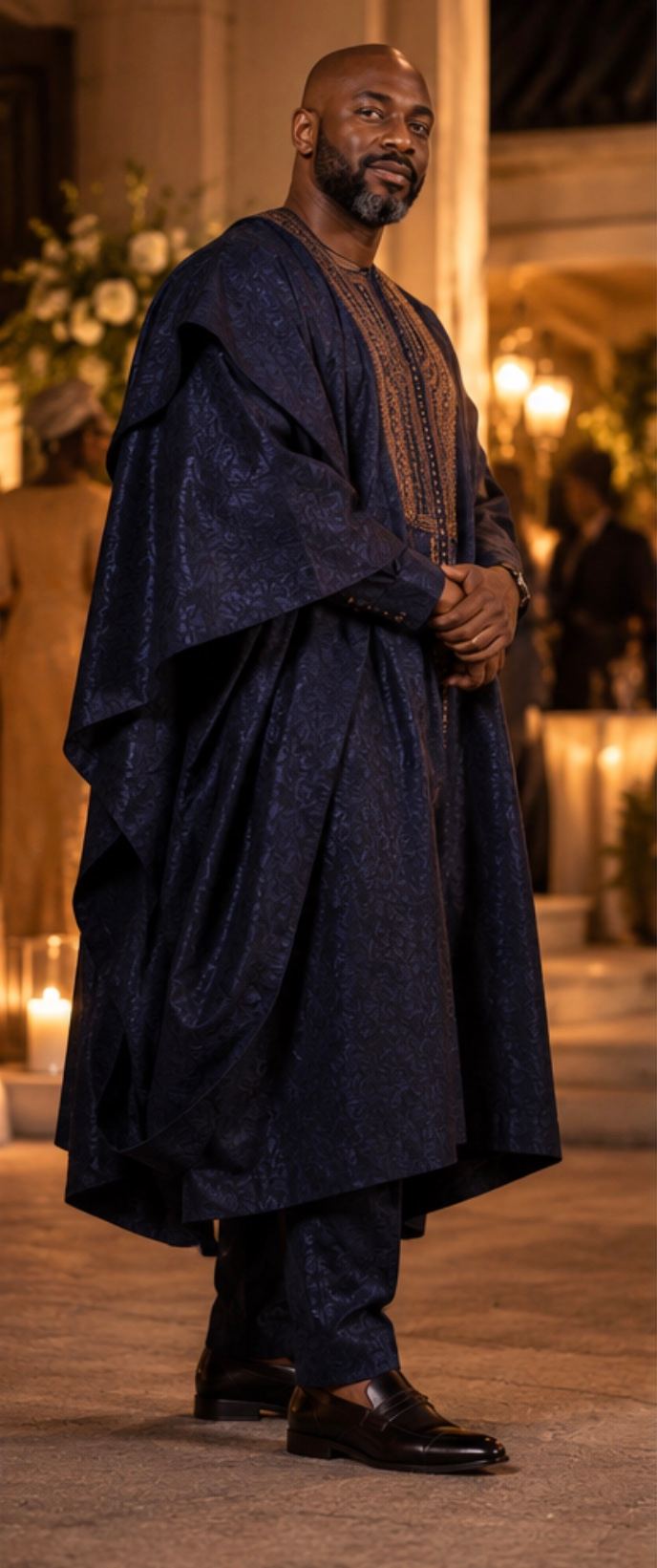 The midnight-blue agbada from a three-quarter angle, showing the drape of the sleeves.