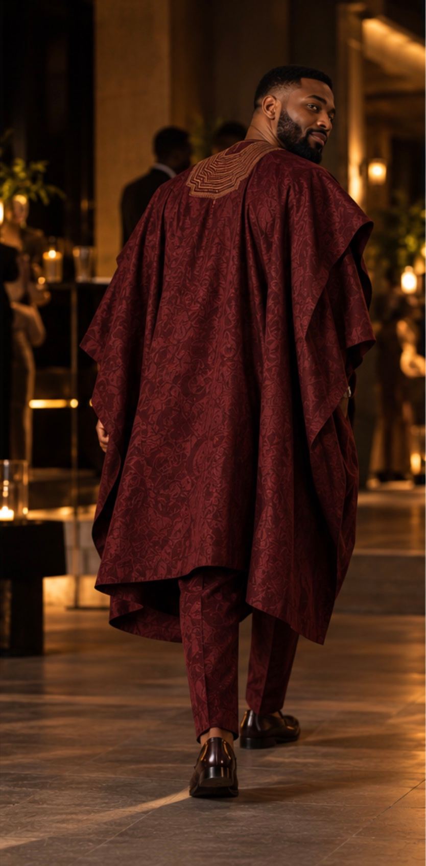 Oxblood agbada from a three-quarter angle.