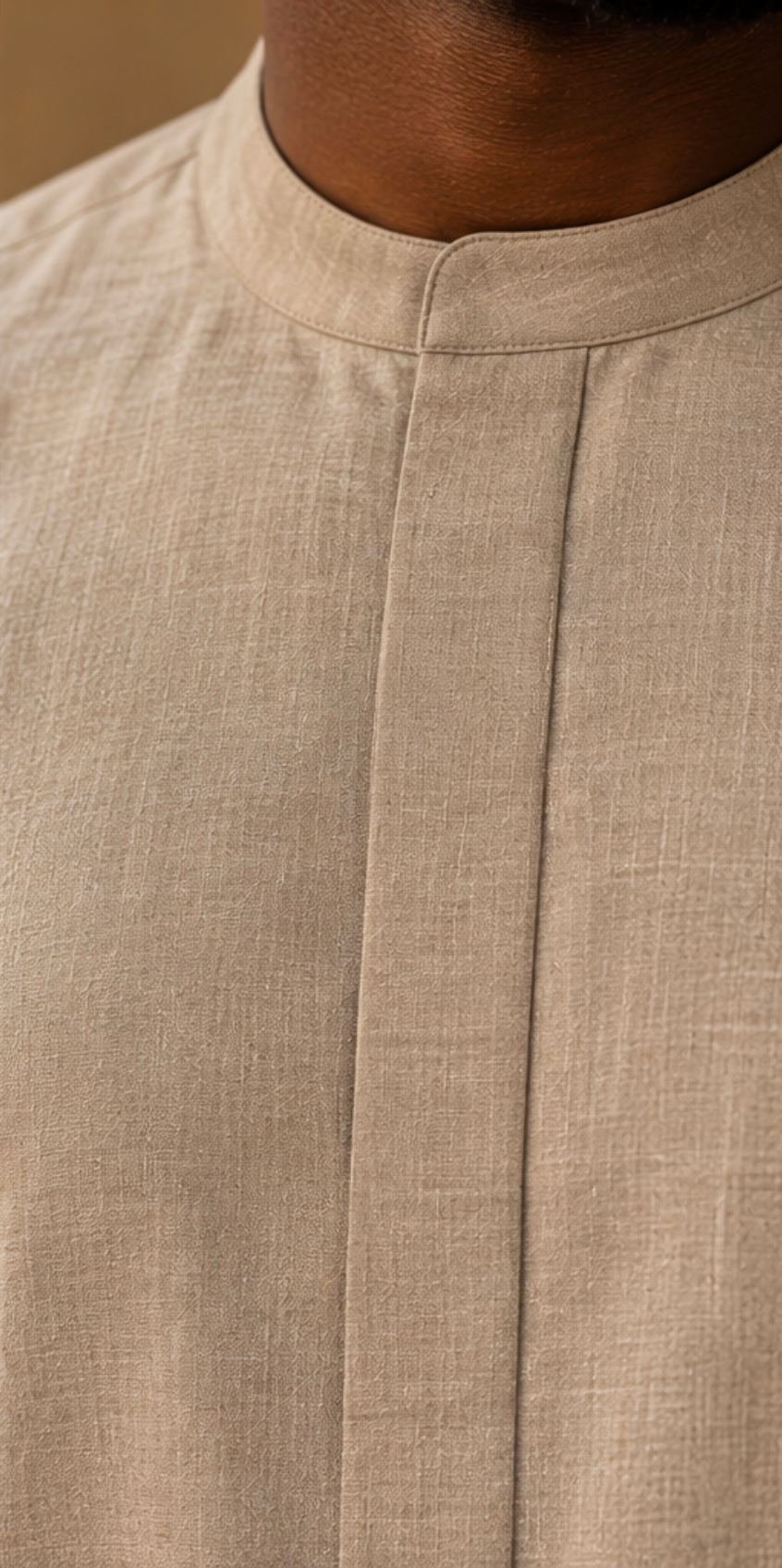 Close-up of fabric weave and placket stitching on the stone kaftan.