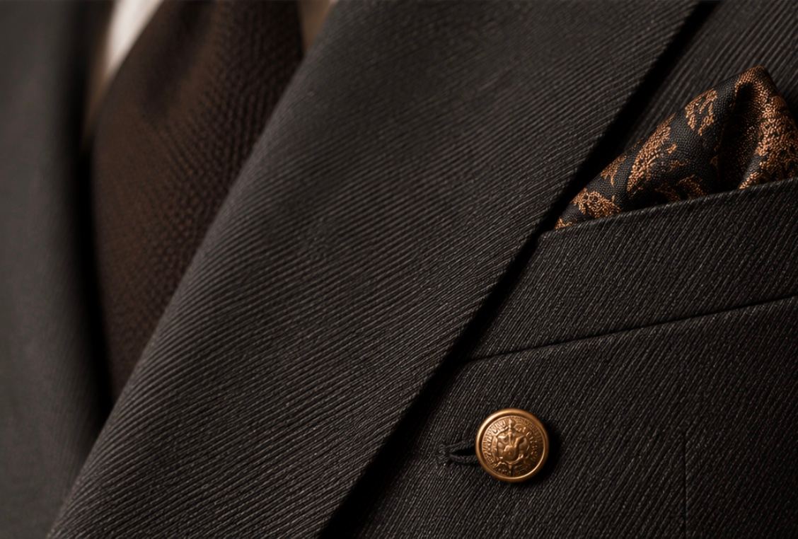 Close-up of charcoal suiting fabric with a fine diagonal texture.